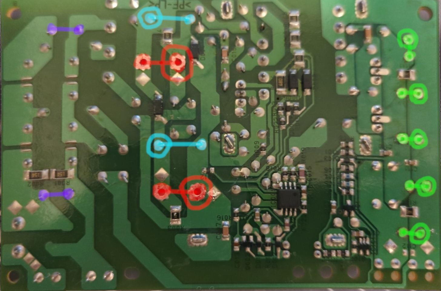 Photo showing the bottom (solder side) of the PSU. The solder joins for each of the components are highlighted the same colour as the component.