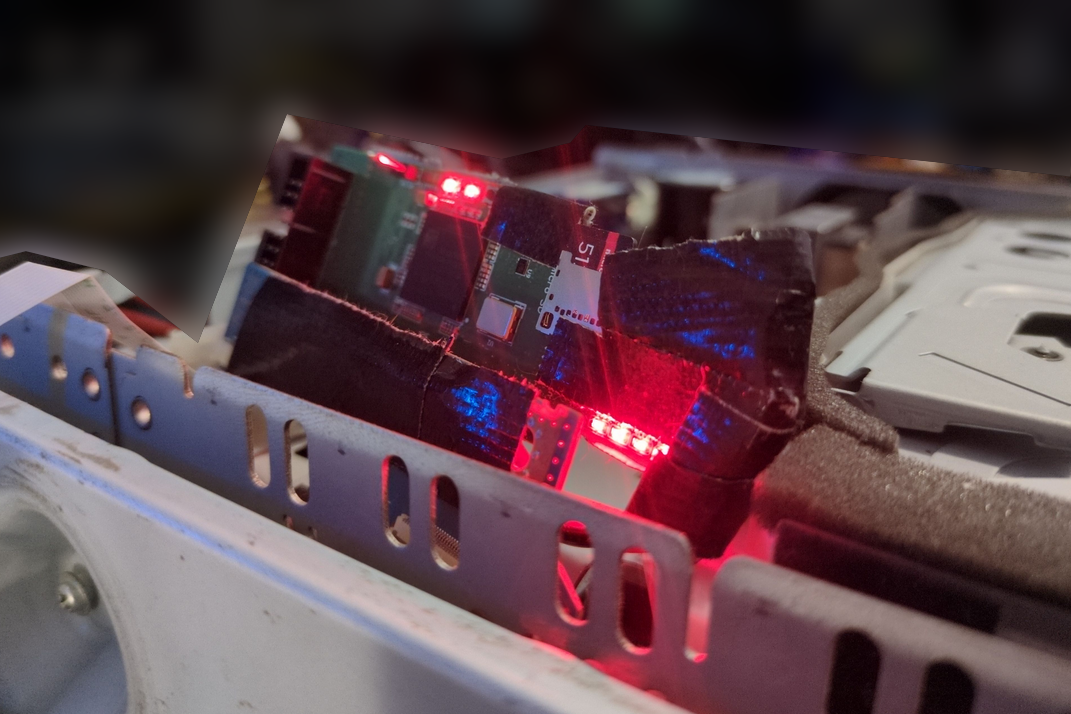 Photo showing the PSX's HDD board, with the ATA Express connected, in-place in the PSX. The ATA Express sits noticeably higher than the rest of the unit.
