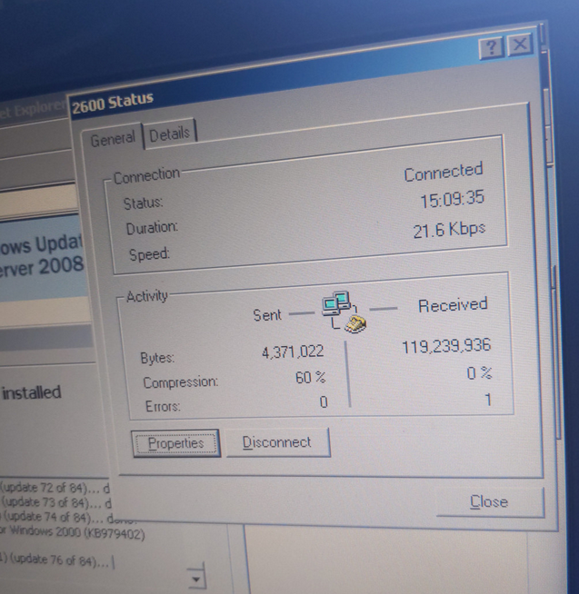 A photo of the dial-up connection statistics window showing 60% compression on the computer's sending side, but 0% on the receiving side.